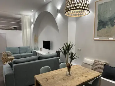 a living room with a couch and a table at Exclusivo Loft con terraza en Ciudad Artes y Cienc in Valencia