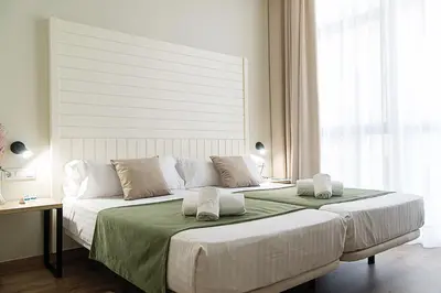 a bedroom with a large bed with two pillows on it at DWO Valencia in Valencia
