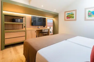 a hotel room with a bed and a tv at DWO Valencia in Valencia
