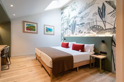 a bedroom with a large bed with a mural on the wall at DWO Valencia in Valencia