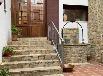 a set of stairs in front of a house with a door at Casa Rural Frigols in Chella