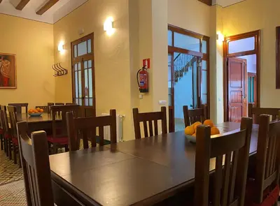 a dining room with a wooden table and chairs at Casa Rural Frigols in Chella