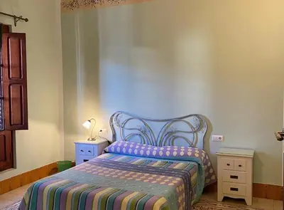 a bedroom with a bed with a colorful blanket on it at Casa Rural Frigols in Chella