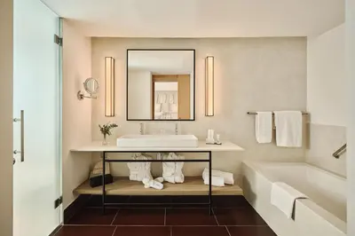 a bathroom with a sink and a tub and a mirror at Hospes Palau de La Mar, Valencia, a Member of Design Hotels in Valencia