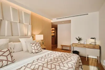 a bedroom with a large bed and a desk at Hospes Palau de La Mar, Valencia, a Member of Design Hotels in Valencia