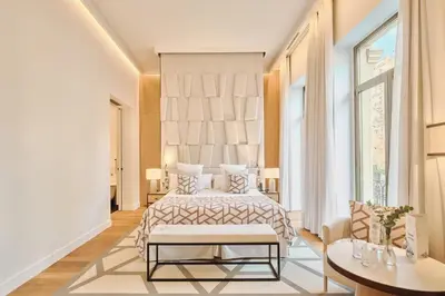 a bedroom with a bed and a large window at Hospes Palau de La Mar, Valencia, a Member of Design Hotels in Valencia
