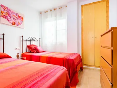 a bedroom with two beds and a dresser and a window at Apartment Jardimar by Interhome in Moncófar