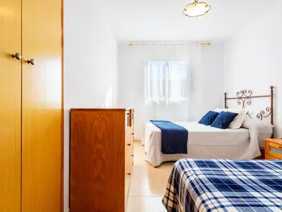 a white bedroom with two beds and a window at Apartment Jardimar by Interhome in Moncófar