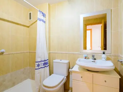 a bathroom with a toilet and a sink and a mirror at Apartment Jardimar by Interhome in Moncófar