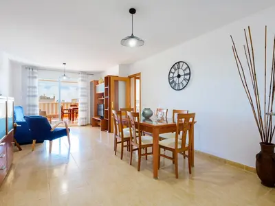 a dining room and living room with a table and chairs at Apartment Jardimar by Interhome in Moncófar