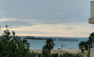 a view of the beach and a pier at Estrella azul/ Blue star in Puerto de Sagunto