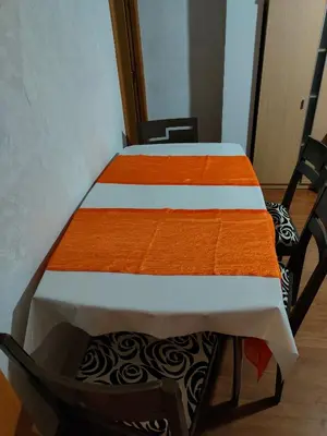a bedroom with two beds with orange and white sheets at Estrella azul/ Blue star in Puerto de Sagunto