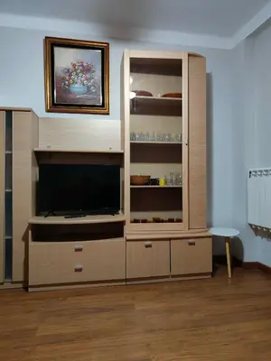 a large wooden entertainment center with a flat screen tv at Estrella azul/ Blue star in Puerto de Sagunto