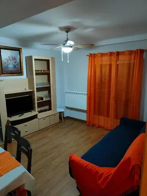 a living room with a couch and a television at Estrella azul/ Blue star in Puerto de Sagunto