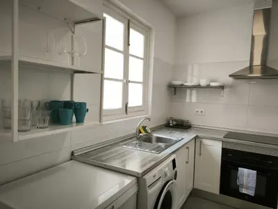 a white kitchen with a sink and a window at FLORIT FLATS - The Ausias March Apartment in Valencia