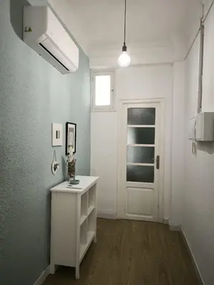 a white room with a white door and a table at FLORIT FLATS - The Ausias March Apartment in Valencia