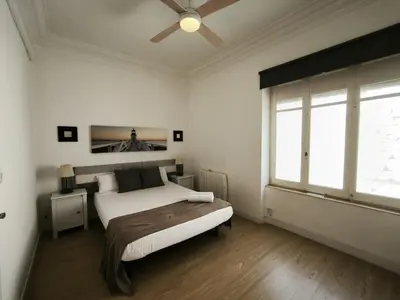 a bedroom with a bed and a ceiling fan at FLORIT FLATS - The Ausias March Apartment in Valencia