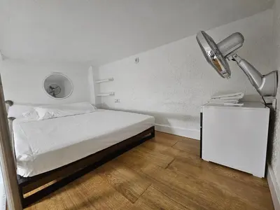 a bedroom with a white bed and a lamp at Alojame Valencia in Valencia