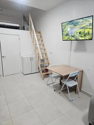 a dining room with a table and a staircase at Alojame Valencia in Valencia