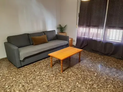 a living room with a couch and a coffee table at UIM Mediterraneo M Cristina con garaje Wifi in Puerto de Sagunto