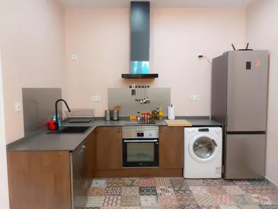 a kitchen with a refrigerator and a washing machine at Ruzafa in love in Valencia