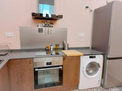 a kitchen with a washing machine and a washer at Ruzafa in love in Valencia