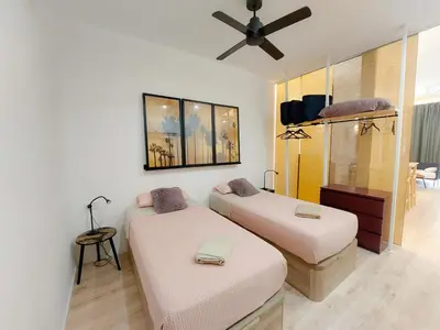 a room with two beds and a ceiling fan at Ruzafa in love in Valencia