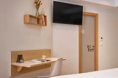a room with a desk with a tv on the wall at Rooms Ciencias in Valencia