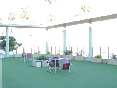 a room with chairs and tables on a roof at Anka Beach Apartment Patacona in Valencia