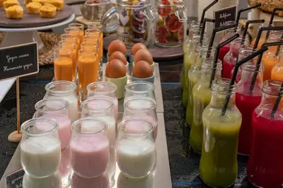 a table with many different types of drinks in jars at Vincci Palace in Valencia