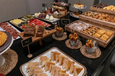 a buffet filled with different types of bread and pastries at Vincci Palace in Valencia