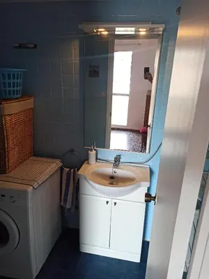 a bathroom with a sink and a mirror at Apartamento en Serra con preciosas vistas. in Serra