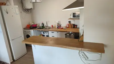 a kitchen with a white refrigerator and a wooden counter top at Apartamento en Serra con preciosas vistas. in Serra