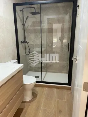 a bathroom with a toilet and a glass shower at UIM Mediterraneo Conqueridor Wifi in Sagunto