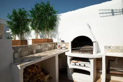 a kitchen with a counter with a pizza oven at BONITA CASA CUEVA CON JACUZZI in Paterna
