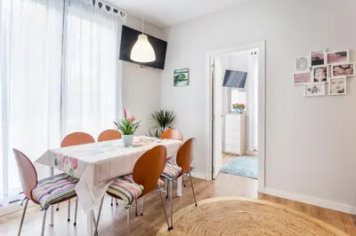 a dining room with a white table and chairs at Piso en la Playa, Wifi gratis y AC in Valencia