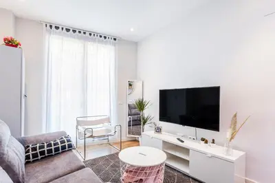 a living room with a couch and a tv at Piso en la Playa, Wifi gratis y AC in Valencia