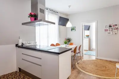 a kitchen with a counter and a dining room at Piso en la Playa, Wifi gratis y AC in Valencia