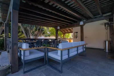 a patio with chairs and a table on a patio at Villa Huerta 2, Paterna, jacuzzi, sauna in Paterna