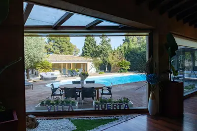 a patio with a table and a pool at Villa Huerta 2, Paterna, jacuzzi, sauna in Paterna