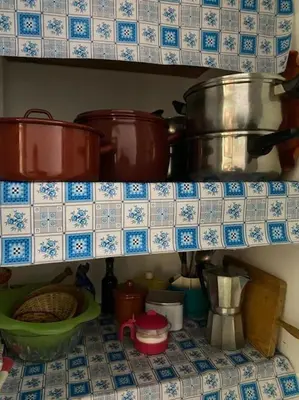 a kitchen with pots and pans on a shelf at Casa en Puerto de Sagunto. Playa in Canet de Berenguer