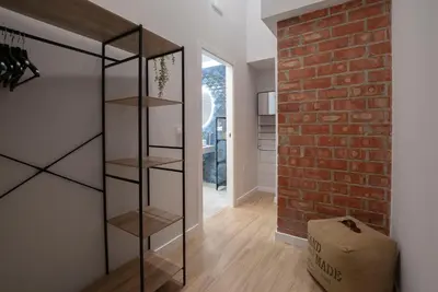 a glass book shelf in a room with a brick wall at Loft con carácter en Valencia. in Valencia