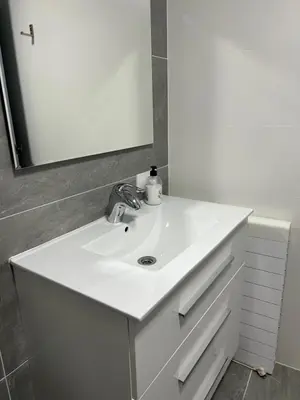 a bathroom with a white sink and a mirror at Acogedora y moderna casa en pueblo in Serra