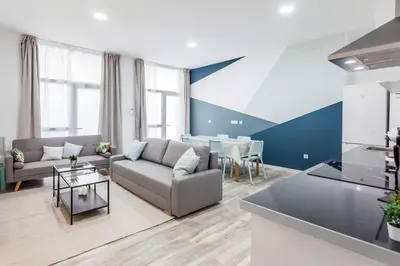 a living room with a couch and a table at Apartamento nuevo cerca de la playa y del centro in Valencia