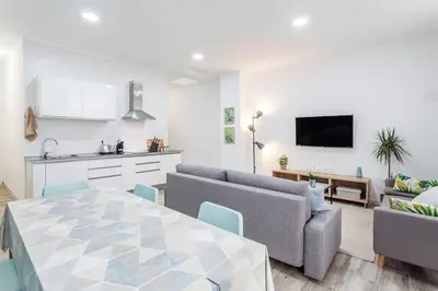 a living room with a couch and a table at Apartamento nuevo cerca de la playa y del centro in Valencia