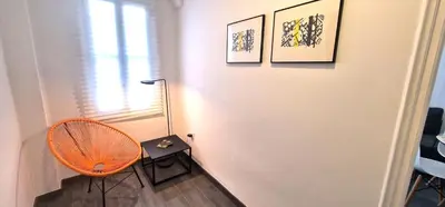 a room with a chair next to a white door at Dionis Silence in Valencia