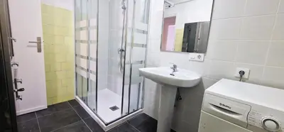 a white bathroom with a sink and a shower at Dionis Silence in Valencia