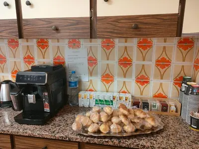 a counter top with a plate of bread and a microwave at Pensión Benavente AP-7 3min coche Playa 5 min Self check-in 24h in Moncófar
