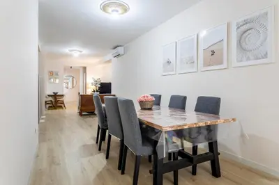 a dining room with a wooden table and chairs at Cala Brull - Acogedor apartamento a 10 minutos de la playa in Valencia
