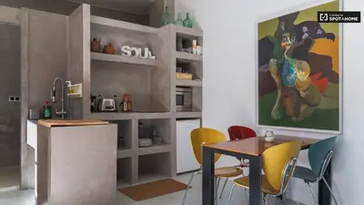 a kitchen with a table and some yellow chairs at Casita artista en bello edificio barrio Ruzafa in Valencia